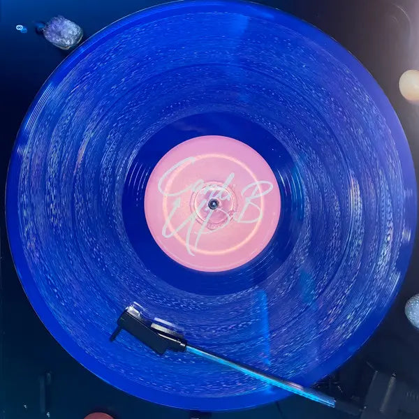 cardi b "up" single on blue vinyl record sitting on a turn table