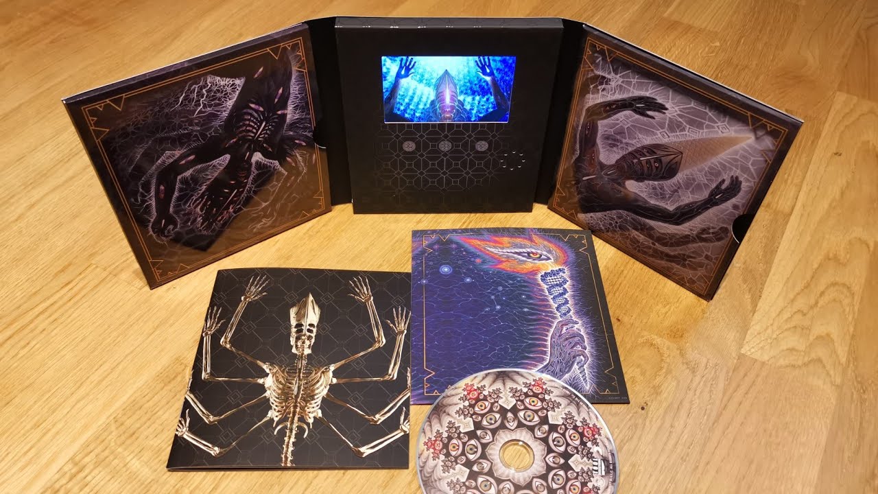 Unfolded tri-fold of Tool's Fear Inoculum album, displaying a mesmerizing CD and two vibrant art cards. An artistic collector's item for music enthusiasts.